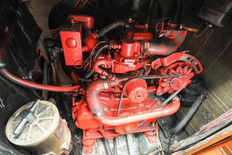 Slide: The Image of Red engine of a 1984 Sabre 38 MKI sailboat, showcasing mechanical components. - 86