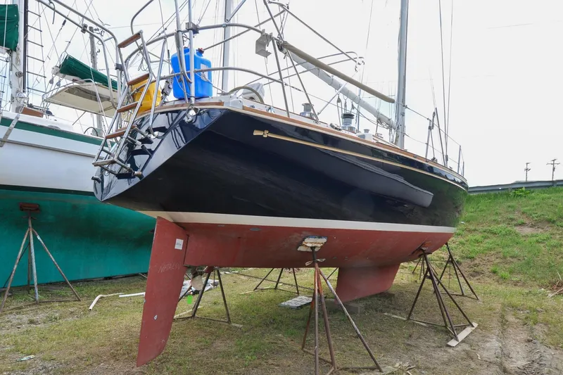 Slide: The Image of 1984 Sabre 38 MKI sailboat on stands, hull and keel visible, outdoor setting. - 88