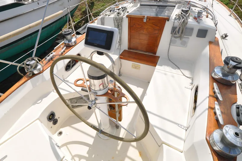 Slide: The Image of 1984 Sabre 38 MKI sailboat cockpit with steering wheel and navigation equipment. - 9