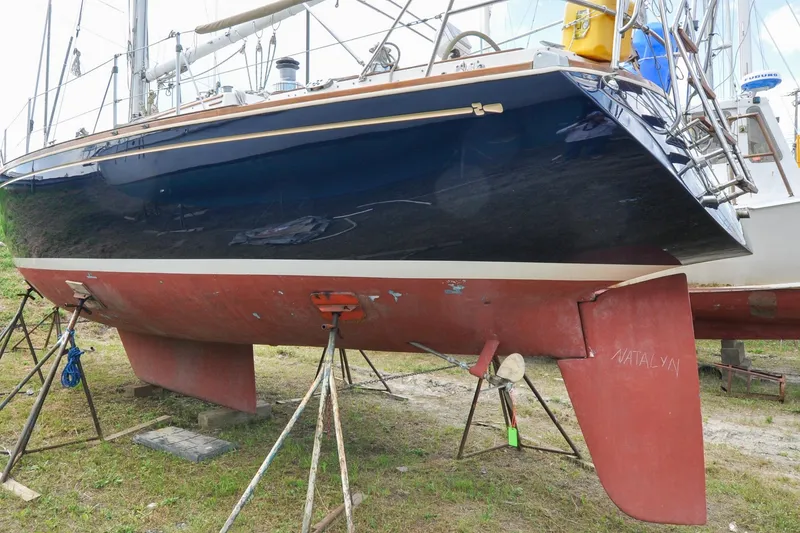 Slide: The Image of 1984 Sabre 38 MKI sailboat on stands, showcasing hull and rudder design. - 93