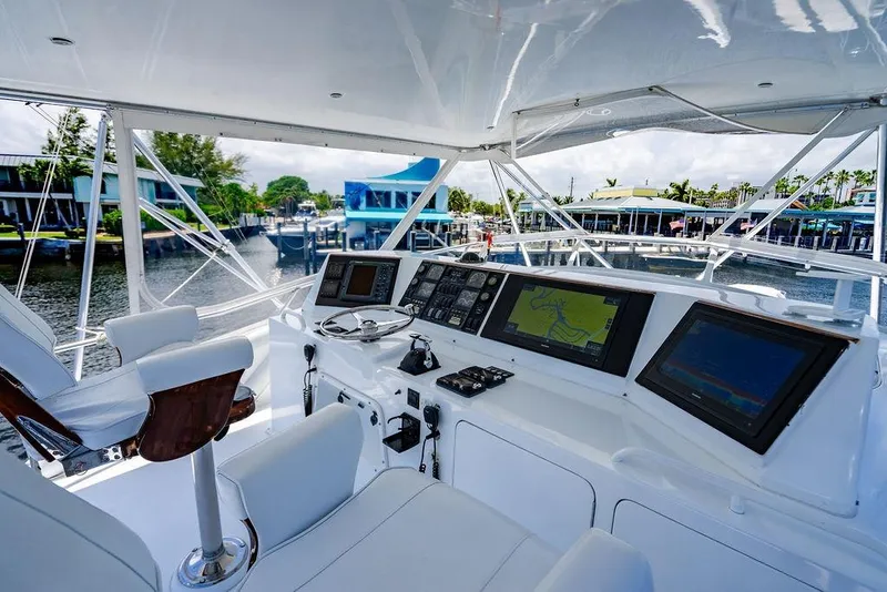 Slide: The Image of 1998 Bertram Convertible yacht cockpit with navigation screens and luxurious seating. - 15