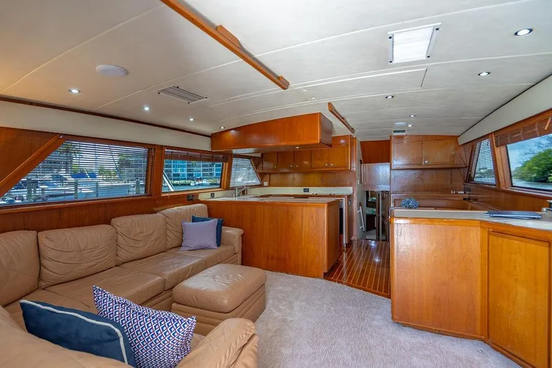 Slide: The Image of Luxurious interior of a 1998 Bertram Convertible yacht with plush seating and wooden cabinetry. - 31
