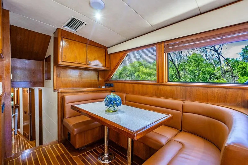 Slide: The Image of Luxurious interior of a 1998 Bertram Convertible yacht with wood finishes and leather seating. - 33