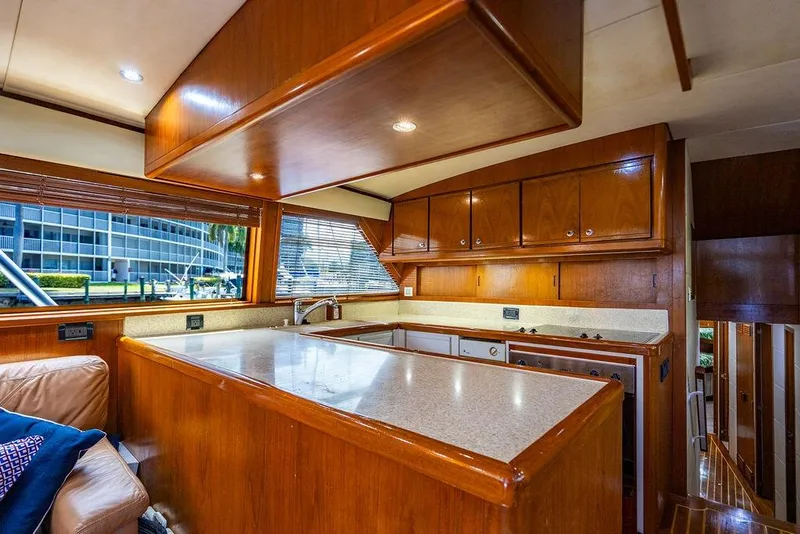 Slide: The Image of Luxurious 1998 Bertram Convertible yacht interior with wooden cabinetry and modern kitchen amenities. - 35