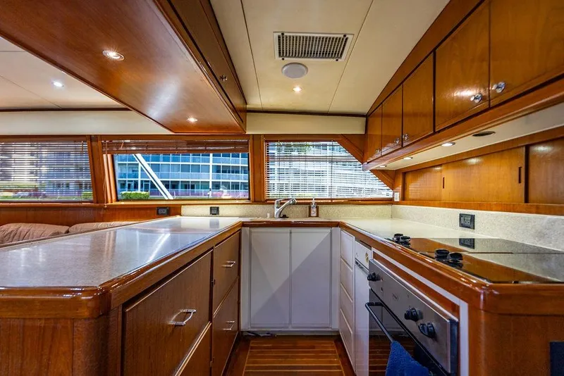 Slide: The Image of Luxurious kitchen interior of a 1998 Bertram Convertible yacht with wooden cabinetry. - 36