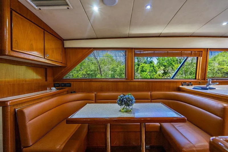 Slide: The Image of Luxurious interior of a 1998 Bertram Convertible yacht with leather seating and wooden finishes. - 40