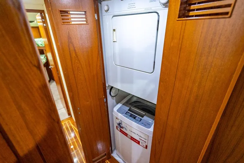 Slide: The Image of Laundry area inside 1998 Bertram Convertible yacht with wooden cabinetry. - 47
