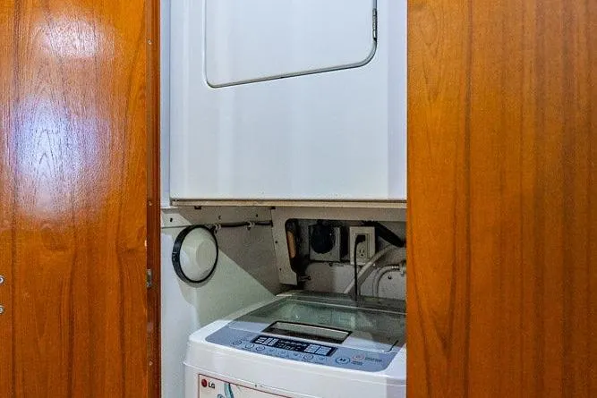 Slide: The Image of 1998 Bertram Convertible interior with LG washing machine in wooden cabinet. - 48