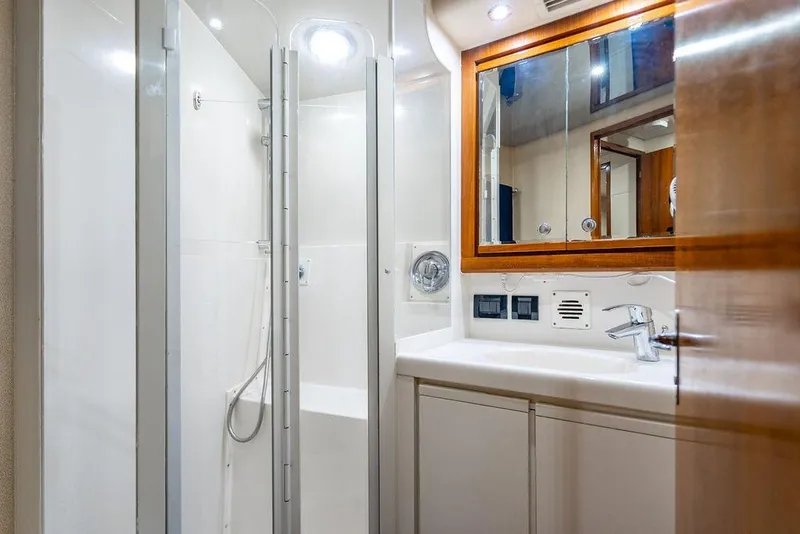 Slide: The Image of 1998 Bertram Convertible yacht bathroom with shower, sink, and mirror. - 55
