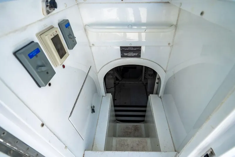 Slide: The Image of Interior view of a 1998 Bertram Convertible yacht, showing stairs and control panels. - 67