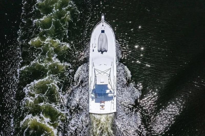 Slide: The Image of Aerial view of 1998 Bertram Convertible yacht cruising through sparkling water. - 72