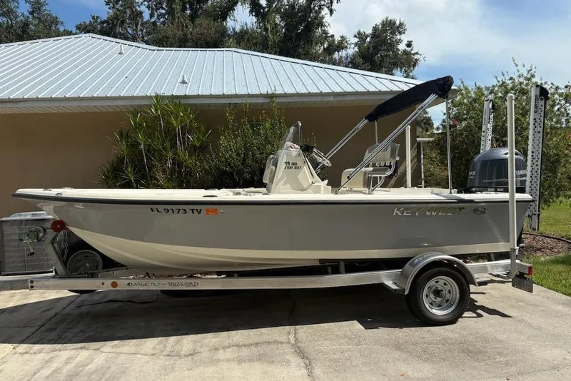 The Image of 2009 Key West 188 Bay Reef boat on trailer, parked in driveway. - 0