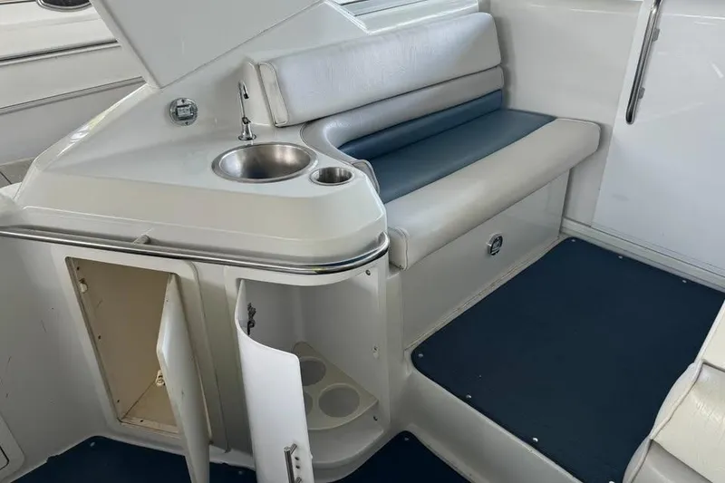 Slide: The Image of 1994 Chris-Craft 322 Crowne interior with seating, sink, and storage compartments. - 10