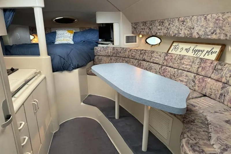 Slide: The Image of Interior of 1994 Chris-Craft 322 Crowne boat with cozy seating and dining area. - 11