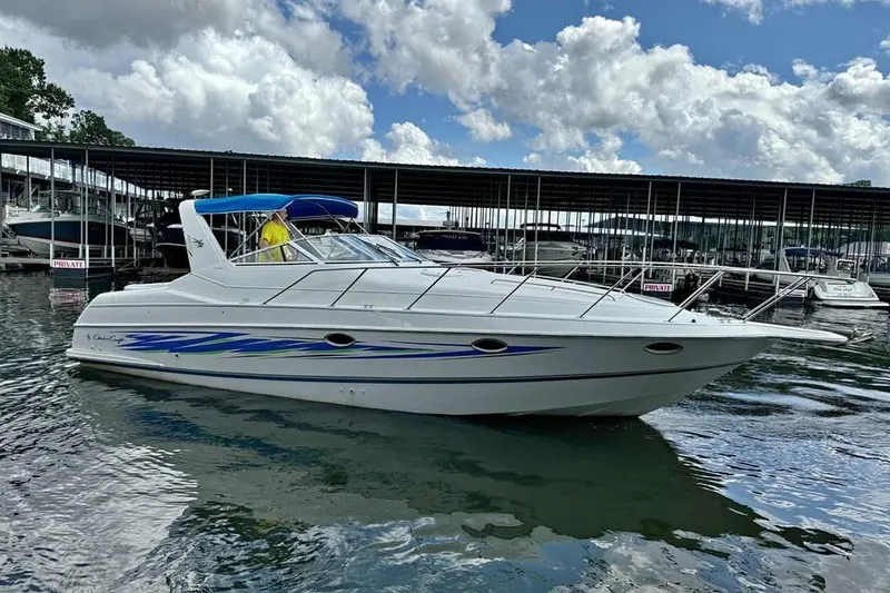 Slide: The Image of 1994 Chris-Craft 322 Crowne boat docked on a sunny day with blue skies. - 13
