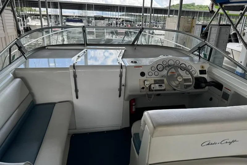 Slide: The Image of 1994 Chris-Craft 322 Crowne boat interior with steering wheel and dashboard at marina. - 18