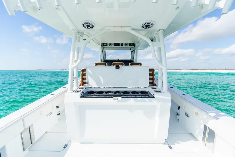 Slide: The Image of 2021 Barker Boatworks 40 HPC on turquoise water, showcasing sleek design and spacious deck. - 19