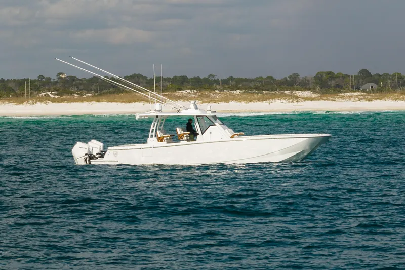 Slide: The Image of 2021 Barker Boatworks 40 HPC cruising on blue ocean near sandy beach. - 5
