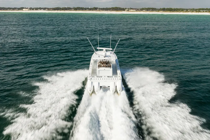 Slide: The Image of 2021 Barker Boatworks 40 HPC cruising on open water, creating a dynamic wake. - 9