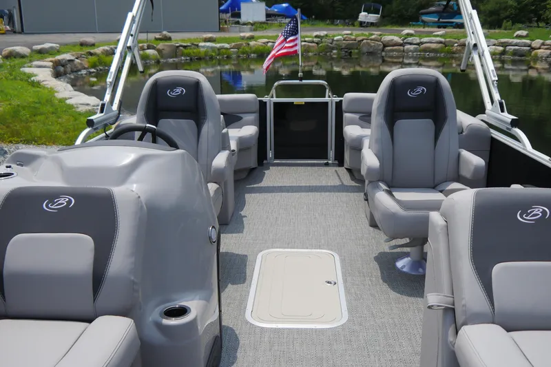 Slide: The Image of 2025 Barletta ARIA 22QC pontoon boat interior with gray seating and American flag. - 3