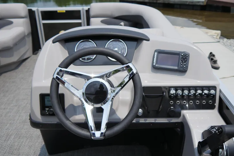Slide: The Image of 2025 Barletta ARIA 22QC boat dashboard with steering wheel and control panel. - 6