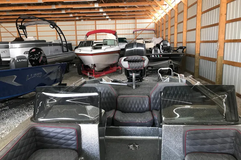 Slide: The Image of Indoor storage of various boats, featuring a 1990 Ranger 375V model. - 10