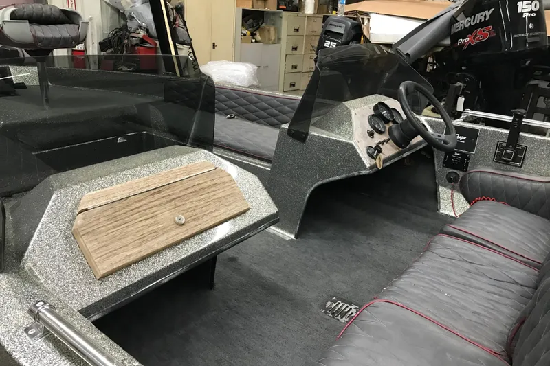 Slide: The Image of 1990 Ranger 375V boat interior with steering wheel, dashboard, and seating. - 19