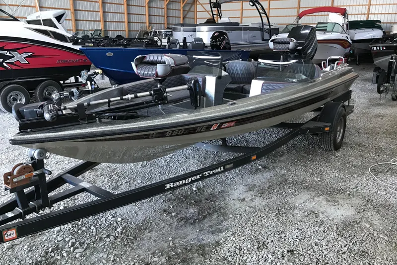 Slide: The Image of 1990 Ranger 375V boat on trailer in storage facility with other boats. - 2