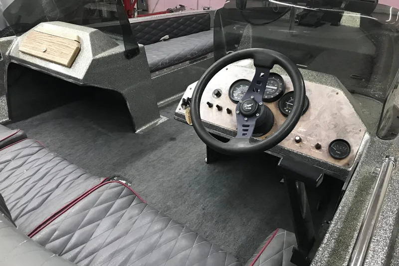 Slide: The Image of 1990 Ranger 375V boat interior with steering wheel and dashboard controls. - 22