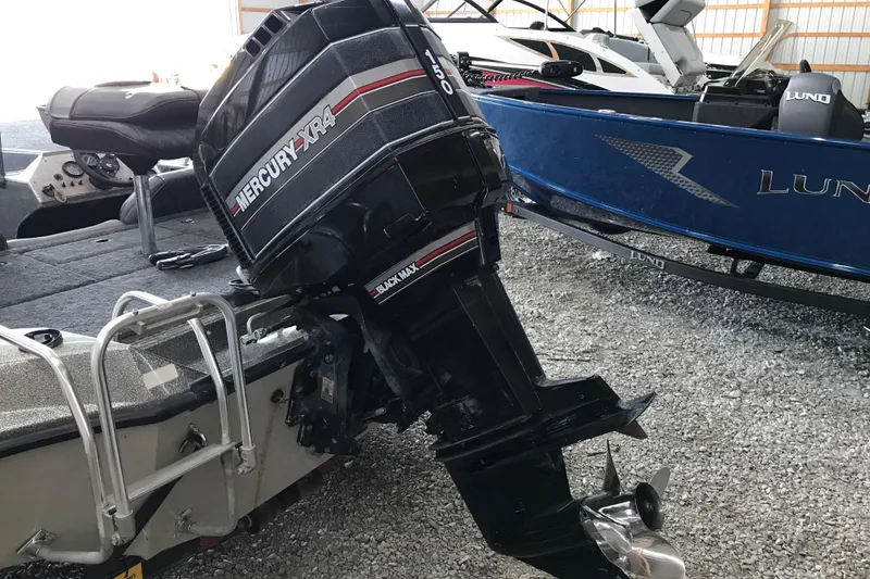 Slide: The Image of 1990 Ranger 375V boat with Mercury XR4 outboard motor in a storage area. - 5