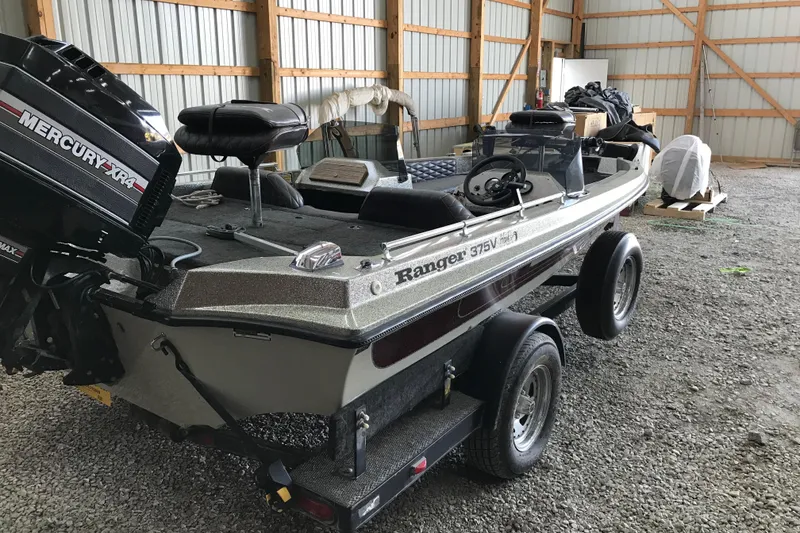 Slide: The Image of 1990 Ranger 375V boat with Mercury XR4 engine in a storage shed. - 6