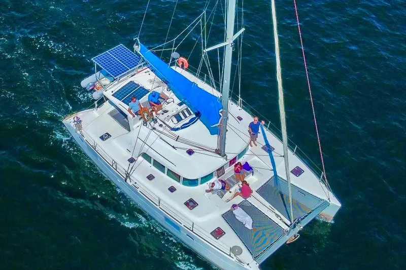 The Image of Aerial view of 2005 Lagoon 440 catamaran sailing with passengers on deck. - 0