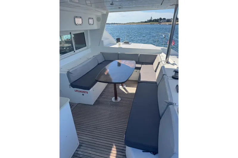Slide: The Image of Spacious deck seating on 2005 Lagoon 440 catamaran with ocean view. - 19