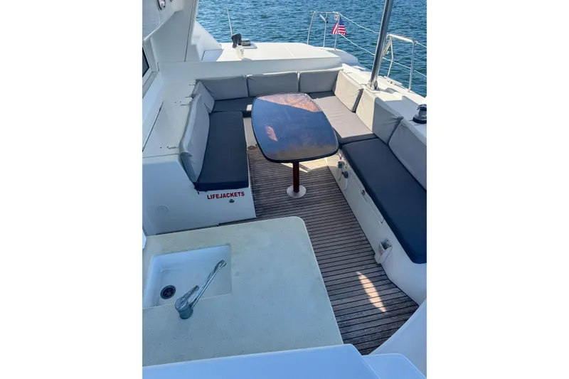 Slide: The Image of Outdoor seating area on 2005 Lagoon 440 catamaran with table and sink. - 20