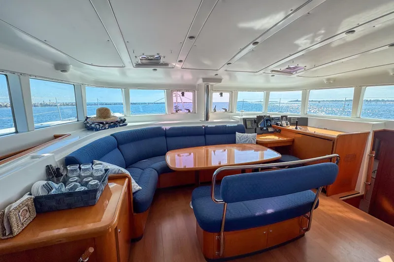 Slide: The Image of Interior of 2005 Lagoon 440 catamaran with panoramic windows and cozy seating area. - 21