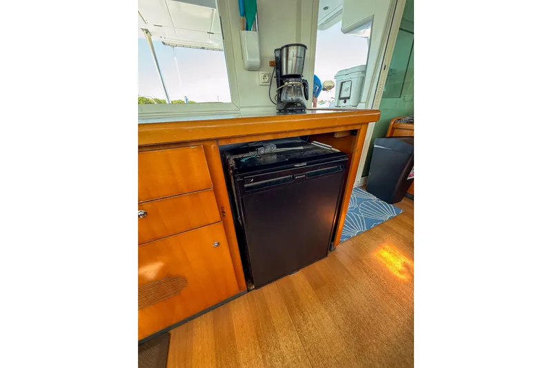 Slide: The Image of Interior of 2005 Lagoon 440 yacht with mini fridge and coffee maker. - 27