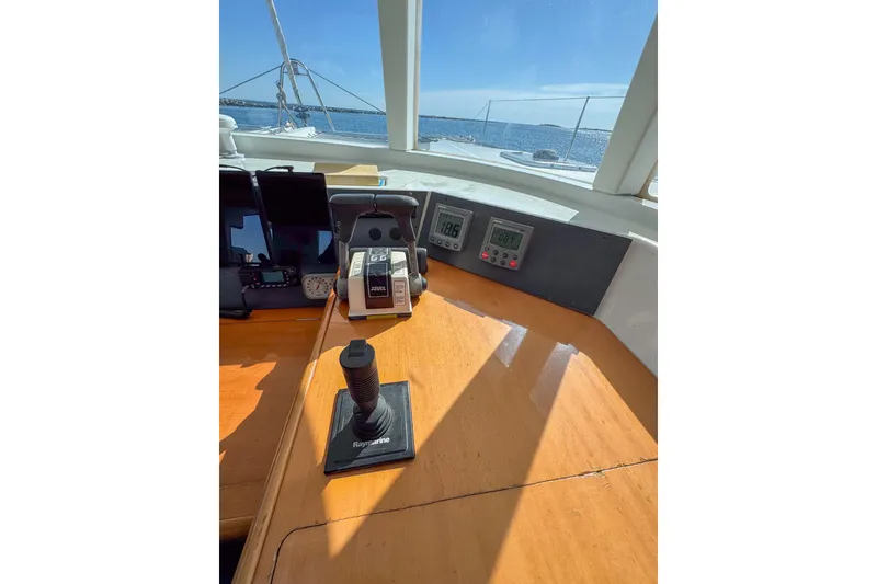 Slide: The Image of Helm of 2005 Lagoon 440 catamaran with navigation controls and ocean view. - 34