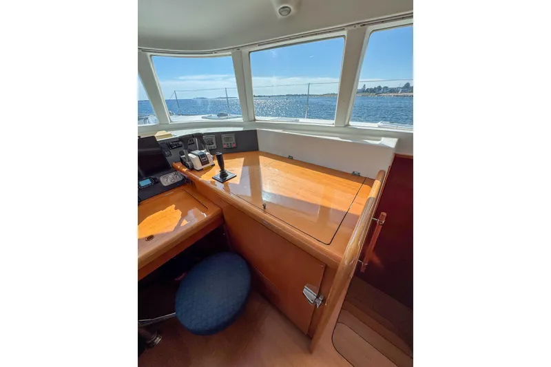 Slide: The Image of Interior view of 2005 Lagoon 440 yacht cockpit with navigation equipment and ocean view. - 35