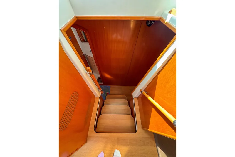 Slide: The Image of Interior stairs of 2005 Lagoon 440 yacht with wooden finish. - 36