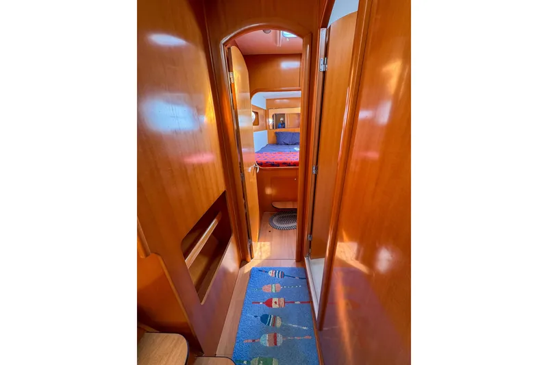 Slide: The Image of Interior view of 2005 Lagoon 440 yacht cabin with wooden finish and colorful rug. - 37