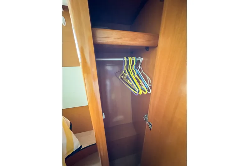 Slide: The Image of Wooden closet with hangers inside a 2005 Lagoon 440 yacht. - 43