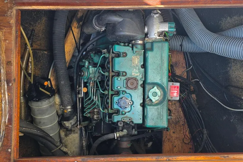 Slide: The Image of Engine compartment of a 2005 Lagoon 440 catamaran, showcasing mechanical components and hoses. - 49