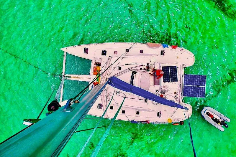 Slide: The Image of Aerial view of 2005 Lagoon 440 catamaran on vibrant turquoise water. - 54