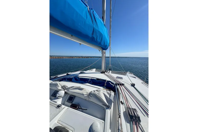 Slide: The Image of Sailing on a 2005 Lagoon 440 catamaran with blue sails on a sunny day. - 7