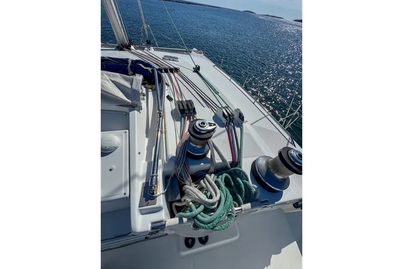 Slide: The Image of Deck of 2005 Lagoon 440 sailboat with ropes and winches, overlooking the sea. - 8