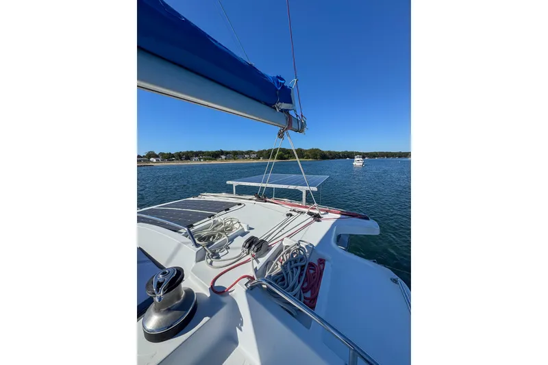 Slide: The Image of 2005 Lagoon 440 catamaran on calm water with clear blue sky. - 9