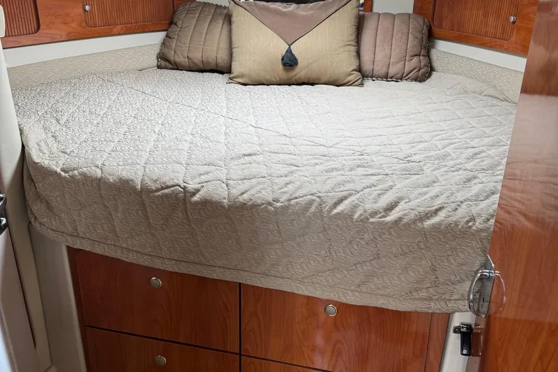 Slide: The Image of Interior cabin of 2006 Larson 3700 Cabrio with cozy bed and wooden storage. - 10