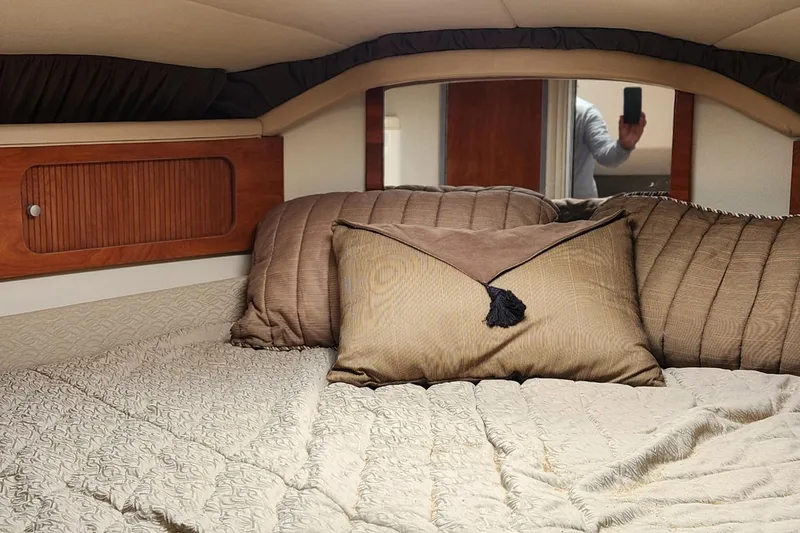 Slide: The Image of Interior cabin of a 2006 Larson 3700 Cabrio with cozy bedding and wood accents. - 11
