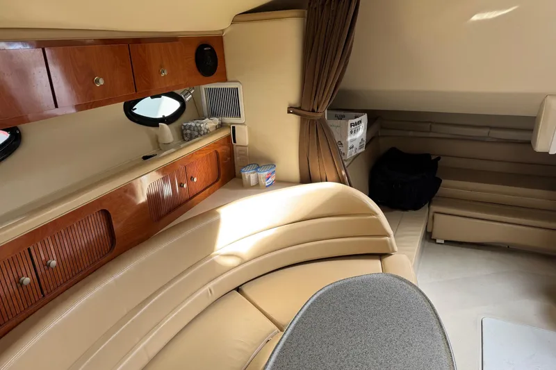 Slide: The Image of Interior of 2006 Larson 3700 Cabrio yacht with beige seating and wooden cabinets. - 12