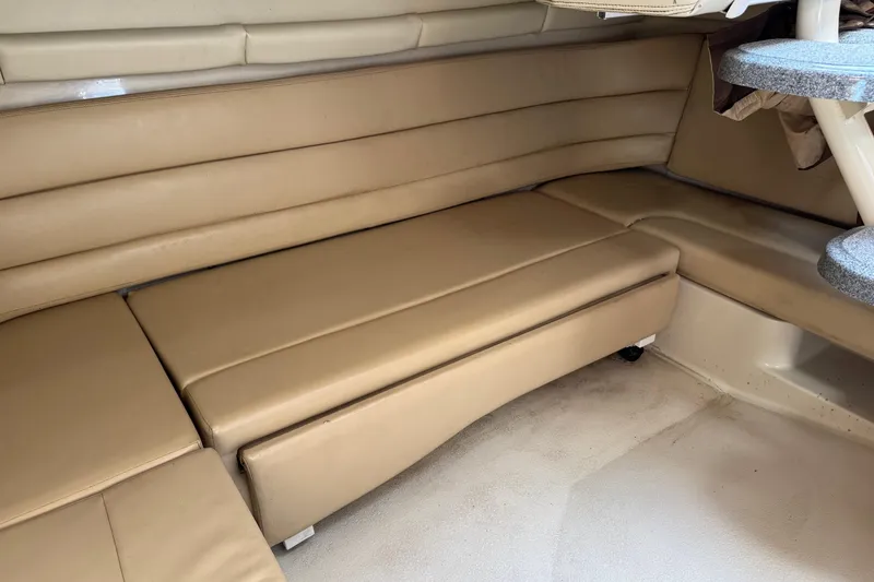 Slide: The Image of 2006 Larson 3700 Cabrio interior with beige seating and compact table. - 15